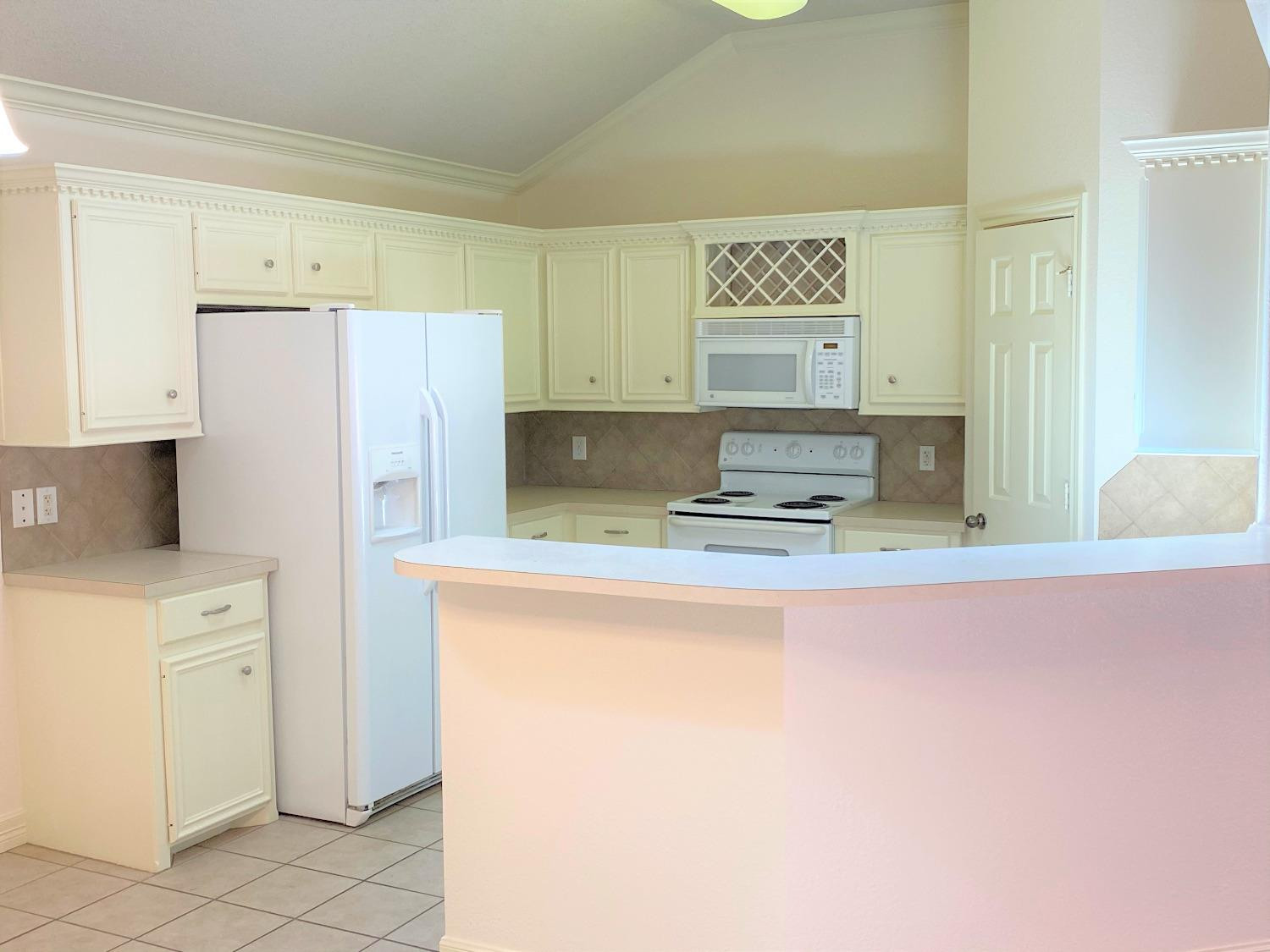6521 8th Street Lubbock, TX 79416 - Photo 13 of 25 a kitchen with stainless steel appliances granite countertop a refrigerator sink and stove