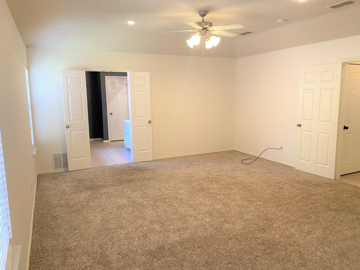 6521 8th Street Lubbock, TX 79416 - Photo 19 of 25 an empty room with closet and a ceiling fan