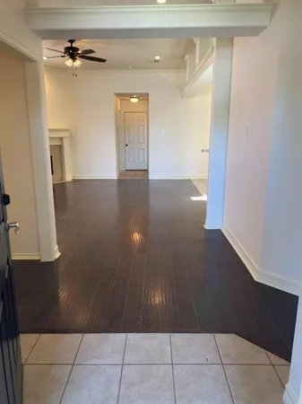 an empty room with wooden floor and cabinet