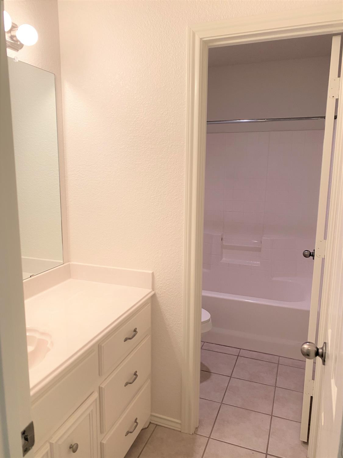 6521 8th Street Lubbock, TX 79416 - Photo 8 of 25 a bathroom with a bathtub and a shower