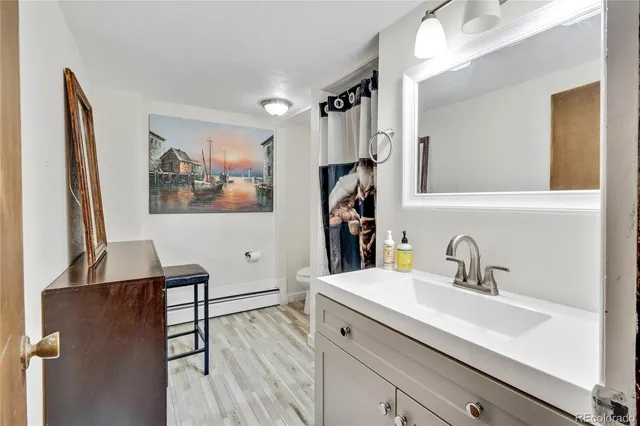 a bathroom with a sink a mirror and a shower