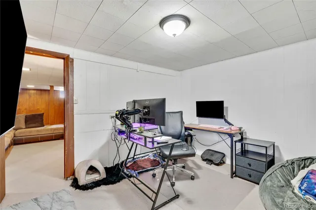 a view of a room with workspace and a window