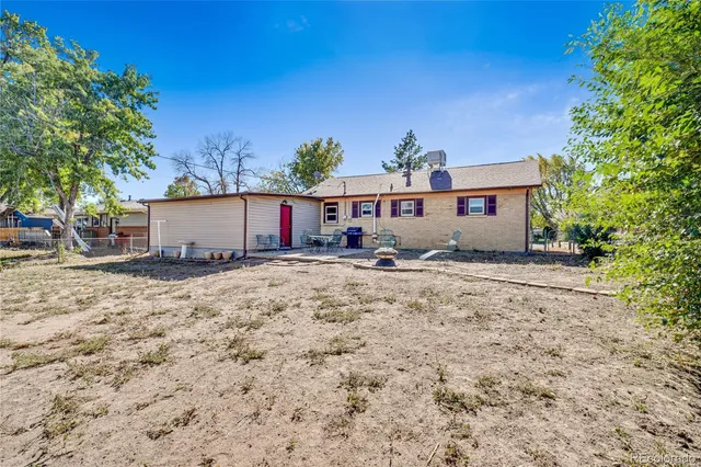 a front view of a house with a yard and covered with snow