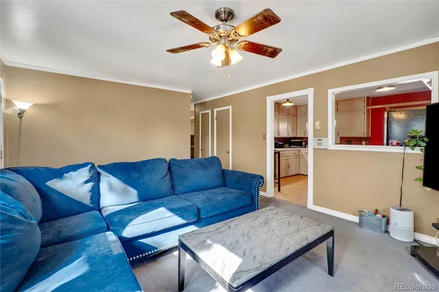 a living room with furniture and kitchen view