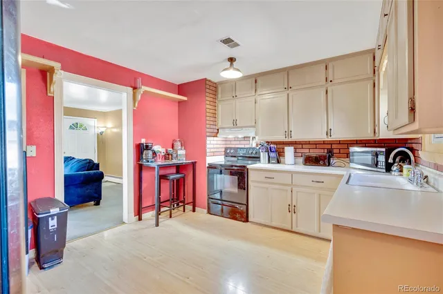 a open kitchen with stainless steel appliances granite countertop a stove and cabinets