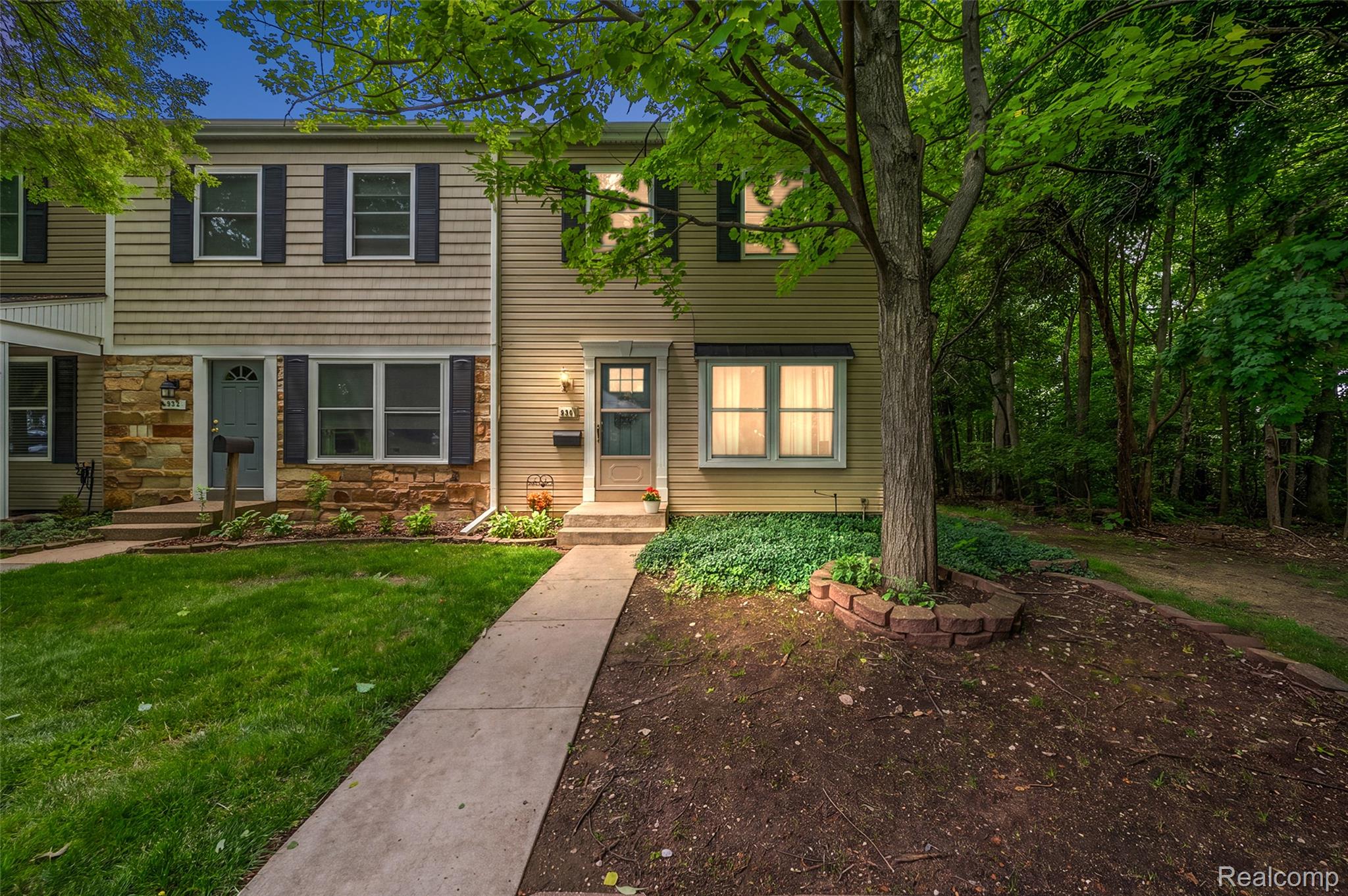 930 Little Hill Court Rochester, MI 48307 - Photo 1 of 38 Two-story townhouse exterior with horizontal siding and stone veneer accents