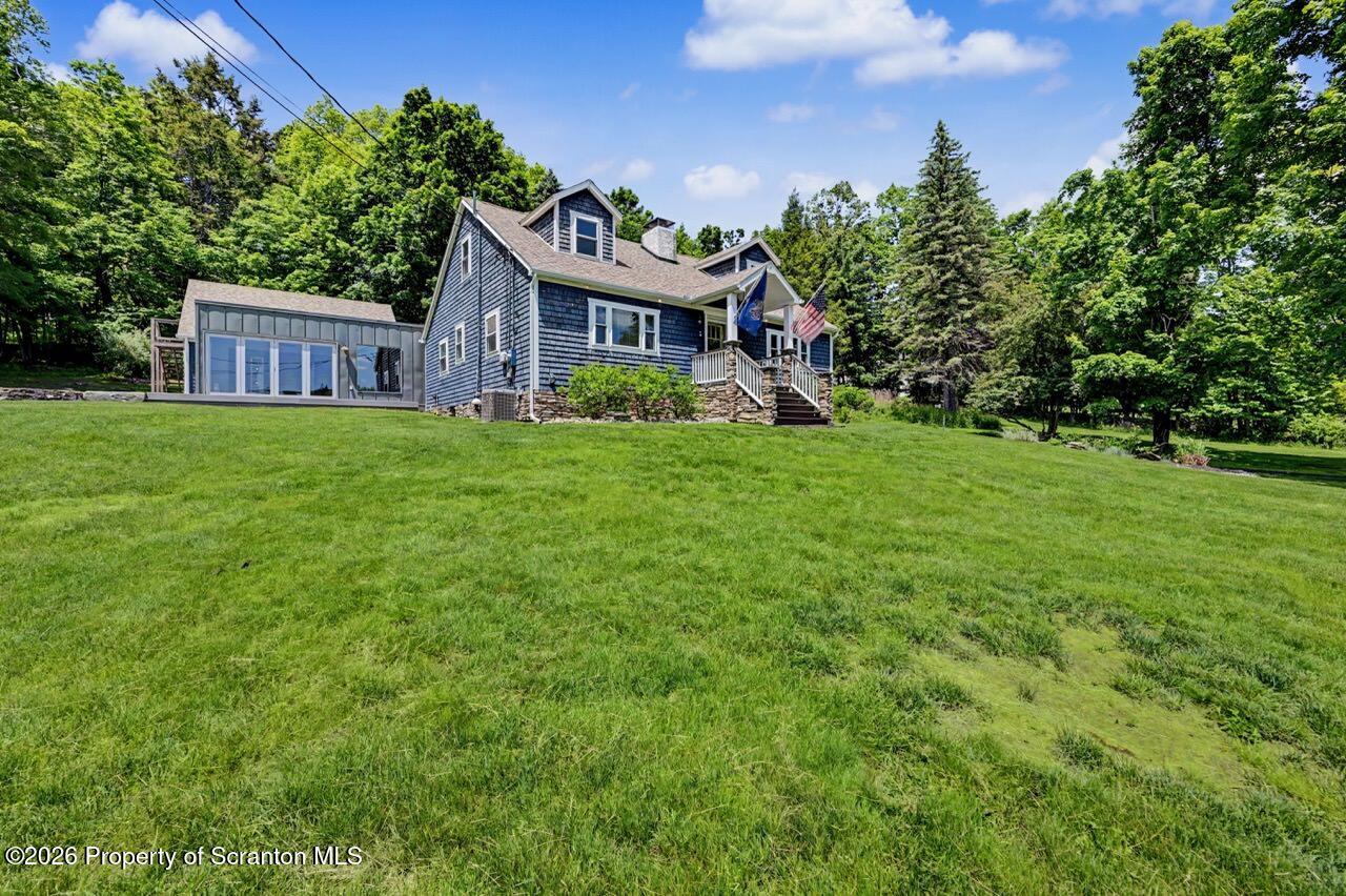 457 Craig Road Dalton, PA 18414 - Photo 5 of 114 a front view of a house with a garden