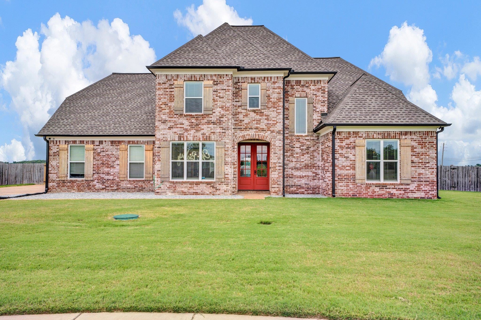 a front view of a house with a garden