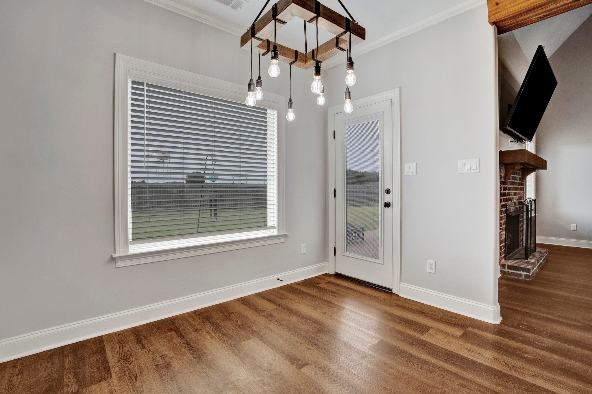 21 Trinity Cove Atoka, TN 38004 - Photo 9 of 21 an empty room with wooden floor and windows
