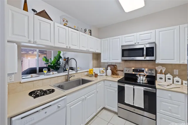 a kitchen with cabinets a sink and appliances