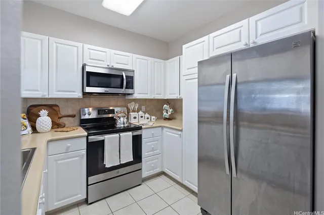 a kitchen with stainless steel appliances granite countertop a refrigerator stove and microwave