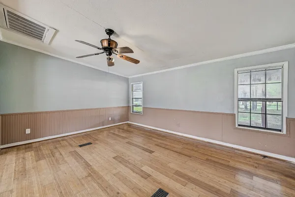 wooden floor in an empty room with a window