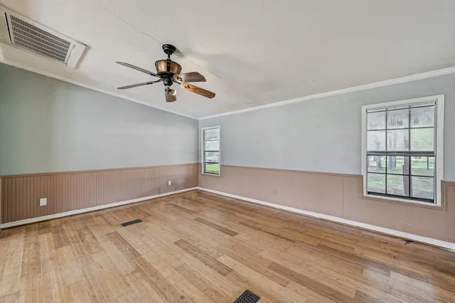 wooden floor in an empty room with a window
