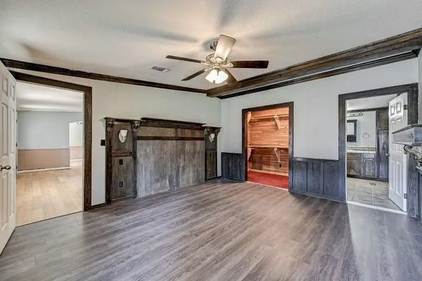 a view of empty room with wooden floor