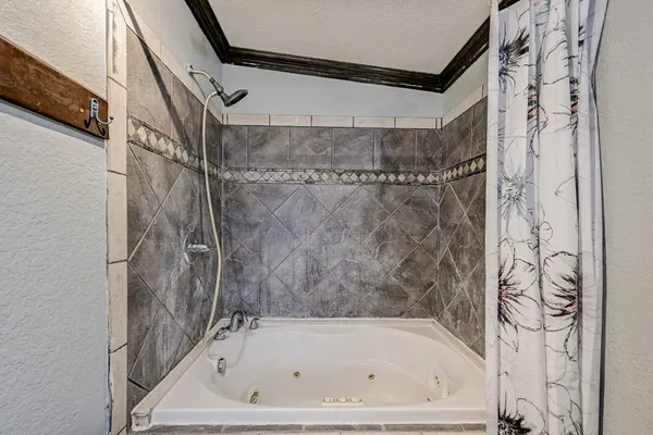a bathroom with a bathtub and shower
