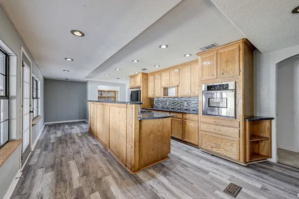a view of a kitchen counter space and wooden floor