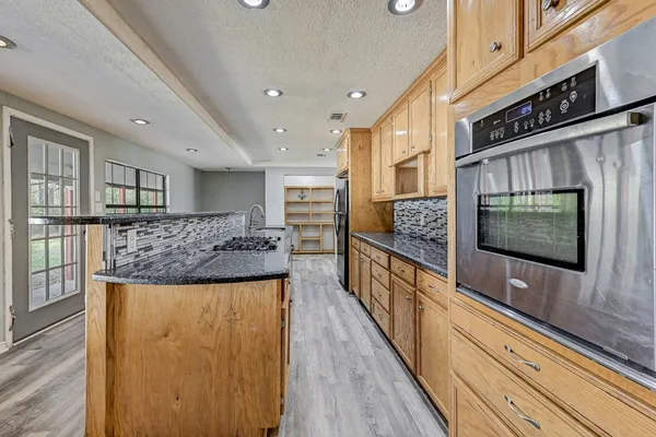 a kitchen with stainless steel appliances granite countertop a stove and a sink