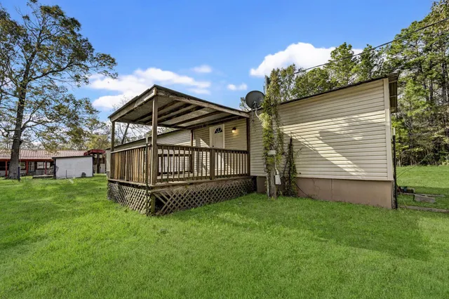a view of house with a yard