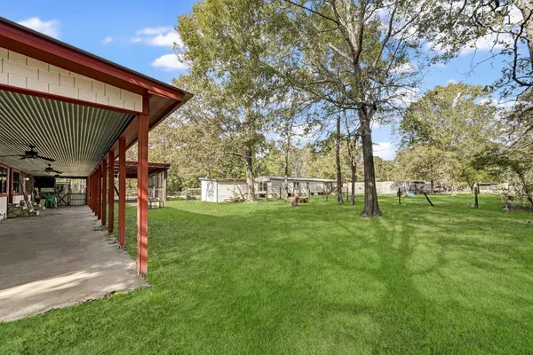 a view of an house with backyard and porch