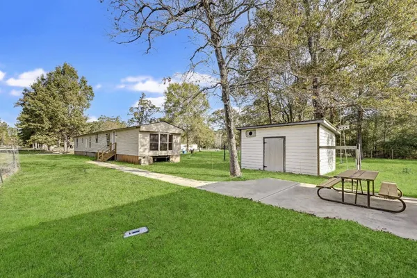 a backyard of a house with table and chairs