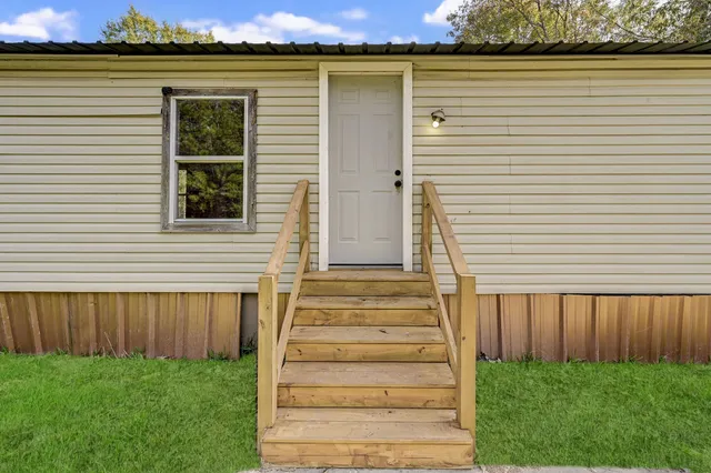 an aerial view of a house with a yard and potted plants