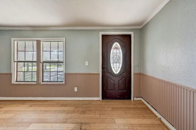 a view of a livingroom with wooden floor and a window