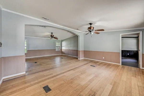 wooden floor in an empty room with a window