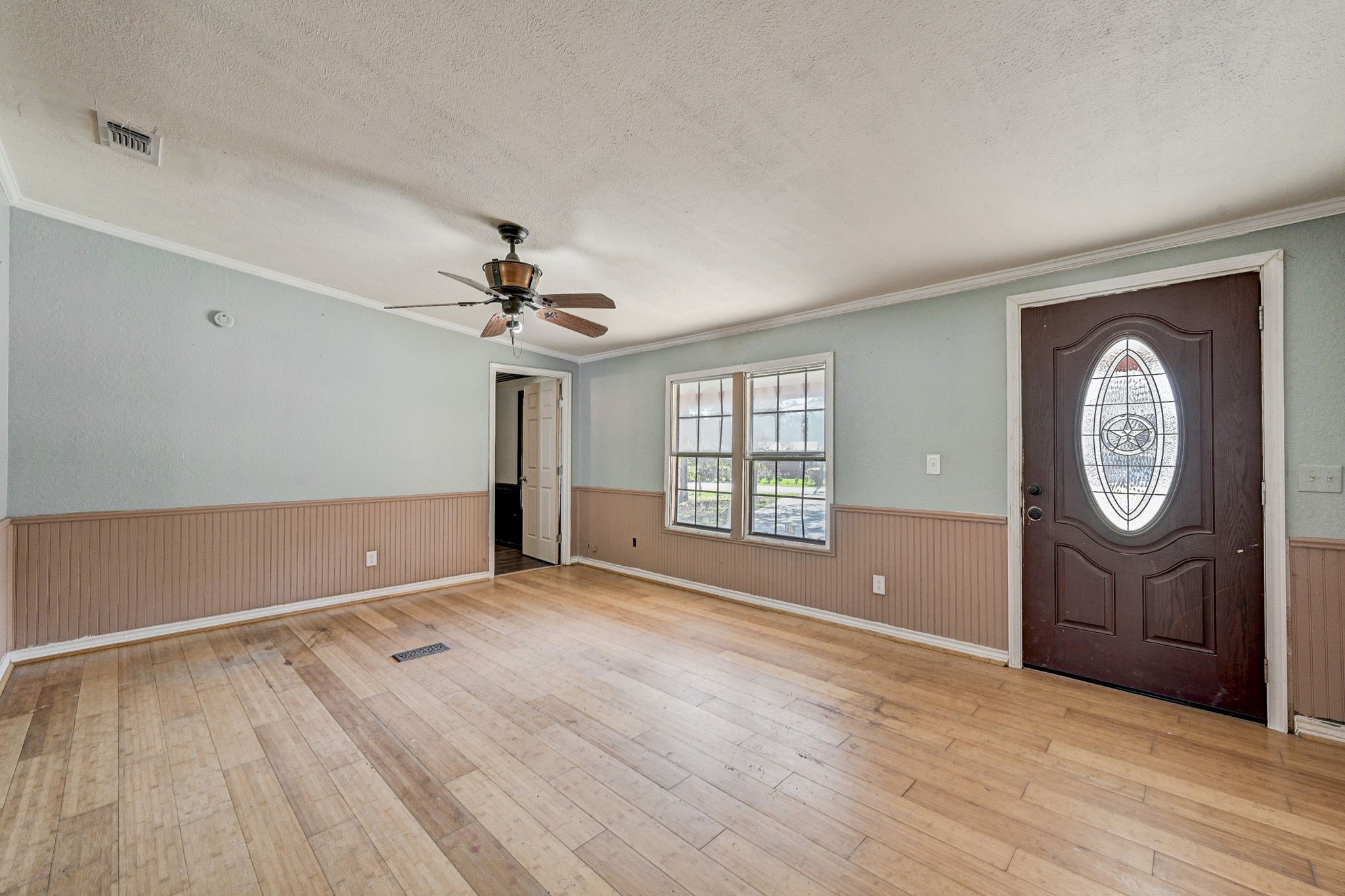 858 Big Hawg Road Trinity, TX 75862 - Photo 9 of 47 a view of an empty room with a window and wooden floor
