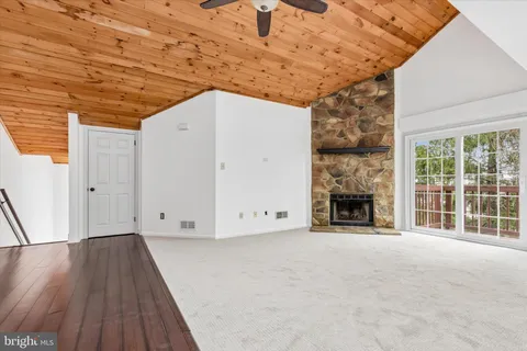 a view of empty room with wooden floor and fireplace