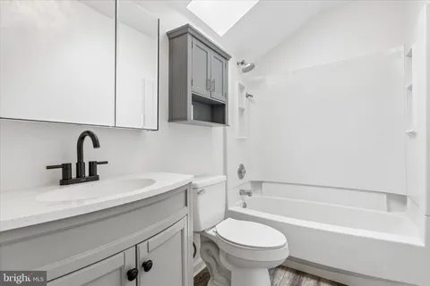 a bathroom with a sink a toilet and a bathtub