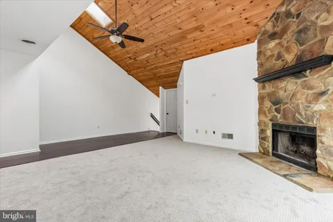 a view of an empty room with a fireplace