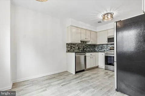 a kitchen with stainless steel appliances a stove a sink and a refrigerator