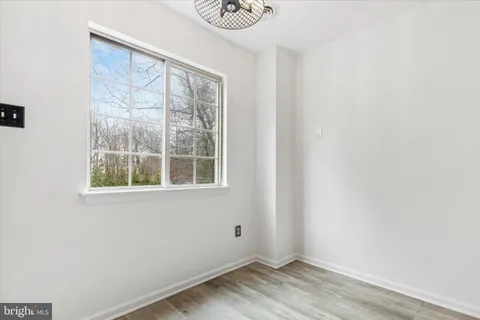 a view of wooden floor and a window in a room