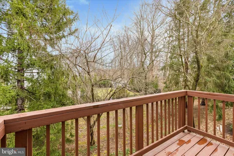 a view of balcony with wooden floor and fence