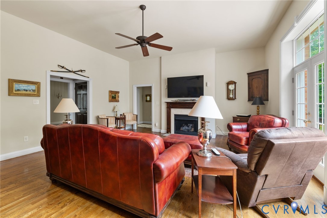 13173 Scotchtown Road Beaverdam, VA 23015 - Photo 22 of 65 a living room with furniture a fireplace and a flat screen tv