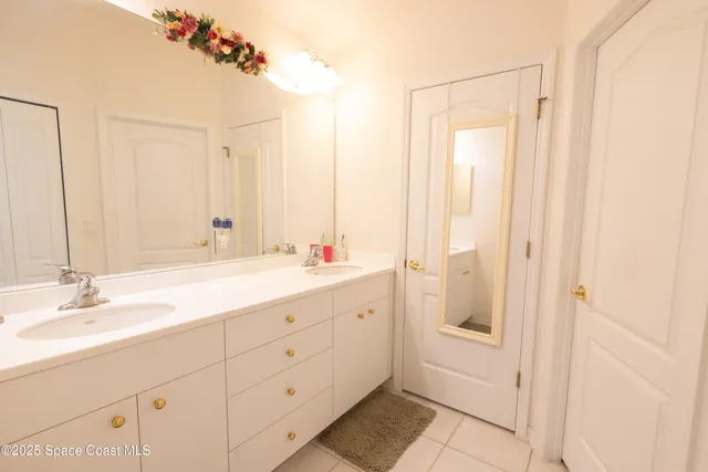 a bathroom with a double vanity sink and mirror