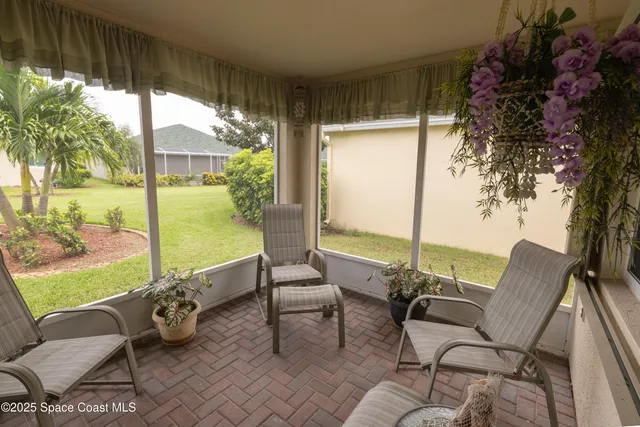 a building outdoor space with patio furniture and garden