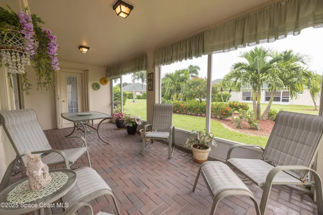 a view of a patio with couches table and chairs and potted plants
