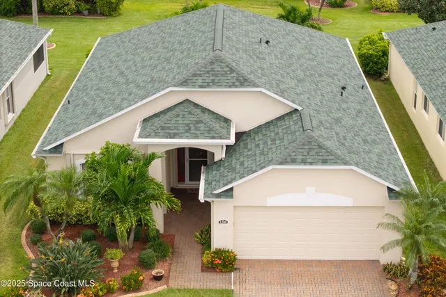 a aerial view of a house with a yard