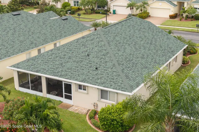 a aerial view of a house with a yard and plants