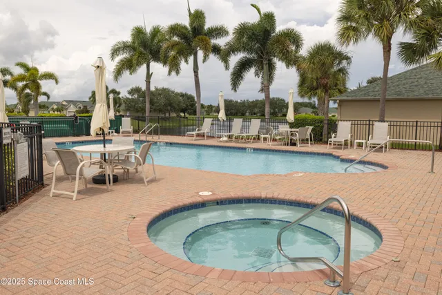 a view of a swimming pool with outdoor seating and a garden