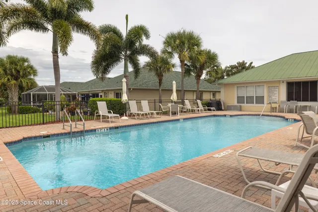 a view of a house with swimming pool and porch
