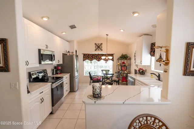 a kitchen with stainless steel appliances kitchen island granite countertop a sink and cabinets