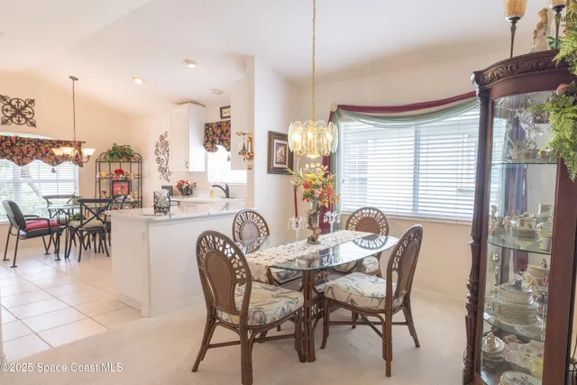 a dining area with furniture and a large window