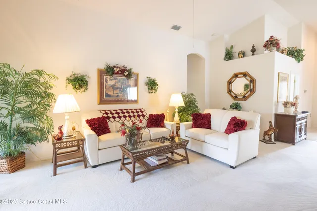 a living room with furniture and a clock