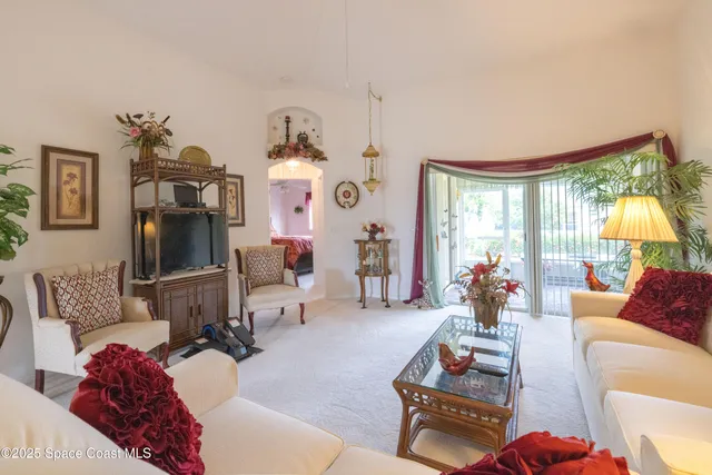 a living room with furniture and a mirror