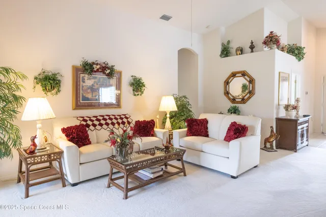 a living room with furniture and a wall painting