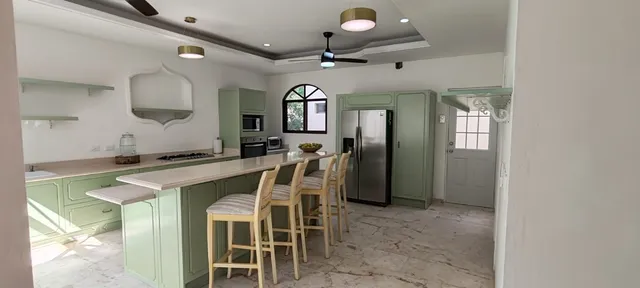 a view of a dining room with furniture and a chandelier