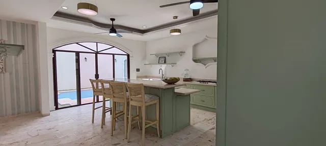 an empty room with windows and ceiling fan