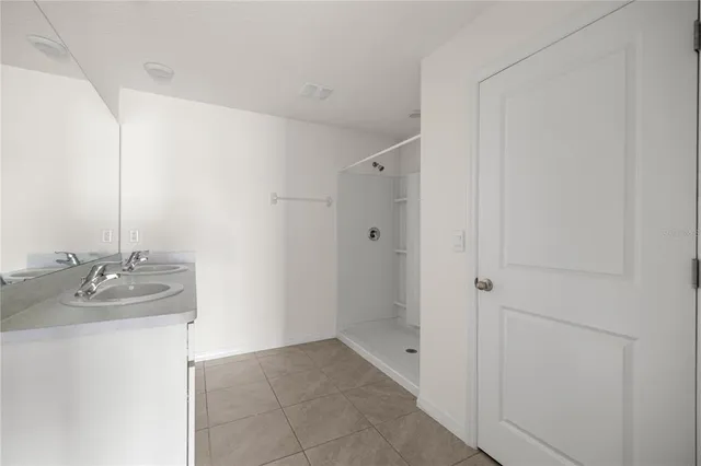 a bathroom with a double vanity sink and mirror